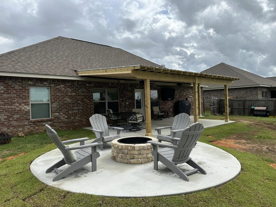 Cedar pergola over a concrete patio with a stacked-stone fire pit